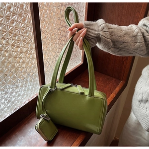 Detail of vintage green underarm bag with matching coin purse and smooth glossy finish