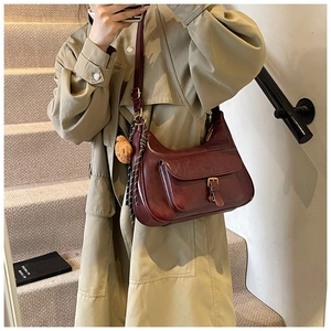 Sac sous le bras en cuir bordeaux vintage avec boucle en métal et breloque ours