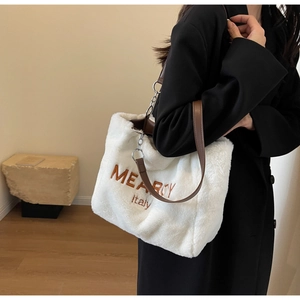 Close-up of white plush tote bag featuring brown MEARRY embroidery and chain leather strap