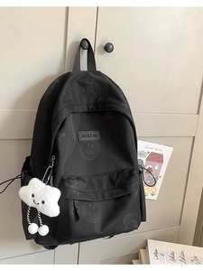 Black nylon backpack with trendy graffiti patterns and a cute cloud plush pendant