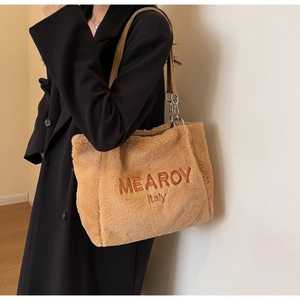 Detail of camel plush tote bag with MEAROY embroidery and metal chain leather strap
