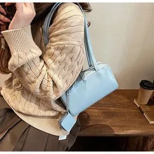 Detail of light blue rectangle shoulder bag with matching square coin purse charm