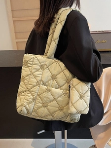 Pistachio green quilted tote bag with floral stitching and matching small charm pouch