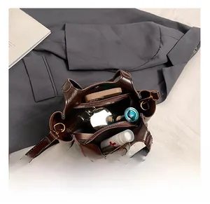 Detail view of the spacious inner capacity of a vintage brown leather bucket bag