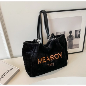 Detail of black faux fur tote bag with orange embroidery and black faux leather strap