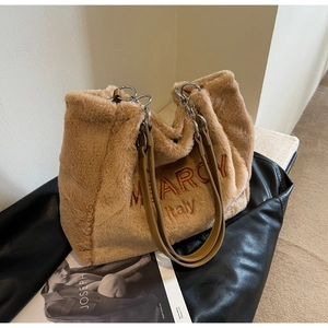 Detail of soft brown plush tote bag showing MEARCY Italy embroidery and metal chain strap
