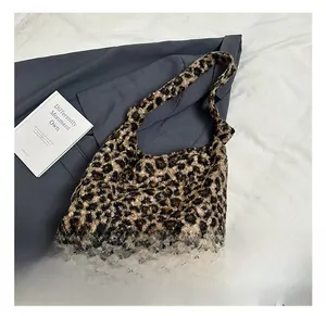 Macro shot of fluffy leopard print plush fabric texture and stylish knotted handle design