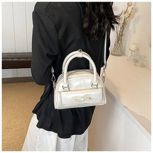 Detailed back view of a chic cream Boston bag with a 3D bow and detachable shoulder strap
