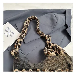 Detail shot of the plush faux fur leopard print tote bag featuring a unique knotted handle