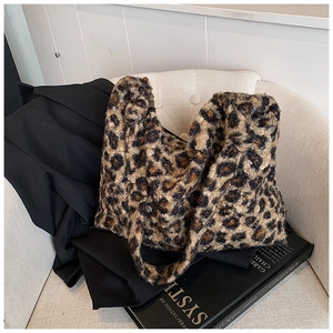 Detailed close-up of leopard print faux fur tote bag on a minimalist white chair