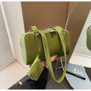 Detail of green glossy leather shoulder bag with matching detachable mini coin purse