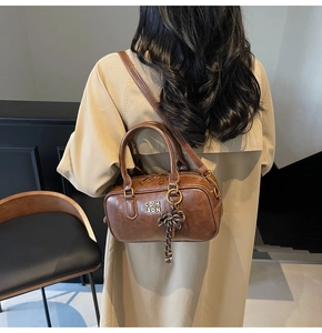 Brown vintage baseball style leather handbag styled with a classic autumn trench coat