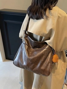 Large dark brown tote bag in vintage faux leather with a furry orange charm detail