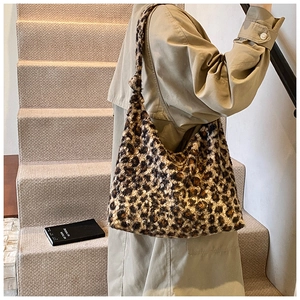 Macro shot of fluffy leopard print plush fabric texture and knotted shoulder strap detail