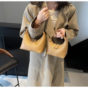 Detailed comparison of camel crescent handbags in two sizes with smooth faux leather finish