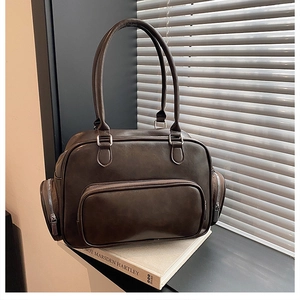 Detailed macro of vintage dark brown faux leather bag with silver zippers and side pockets