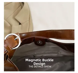 Detailed interior of brown PU tote showing magnetic clasp and zip pocket with lining