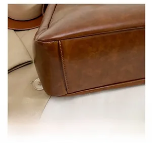 Close-up of precise stitching on brown PU leather bag corner showing texture and craft