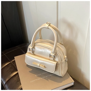 Detail showing pearlescent cream leather texture with bow and silver metal buckle