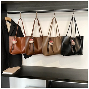 Minimalist faux leather tote bags in four colors with plush bear charm detail