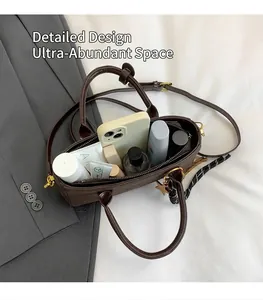 Detail showing high-capacity interior of dark brown leather tote with cosmetics and phone