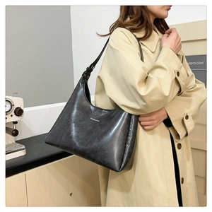 Detail of dark grey leather tote with vintage texture and Fashion & Bags text