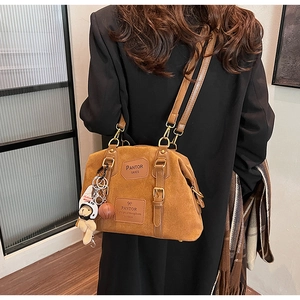 Brown suede shoulder bag with leather patches and cute bear charms shown on model back