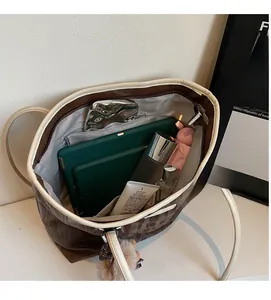 Interior view showing the large storage capacity of the brown tote bag with light lining
