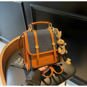 Retro denim and brown leather contrast backpack with cute plush rabbit charm