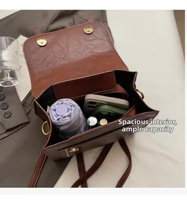 Macro view of spacious interior with laptop and essentials in brown vintage leather bag