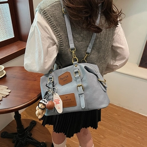 Light blue denim convertible backpack with cute bear charm and brown leather patches