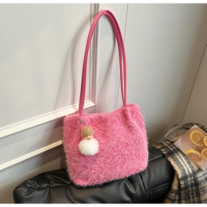 Détail du sac à épaule en peluche rose avec texture fourrure et porte-clé poupée