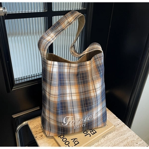 Détail du sac cabas en toile à carreaux avec imprimé Forever Party sur marbre