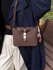 Brown frosted leather crossbody bucket bag with gold twist lock for autumn fashion