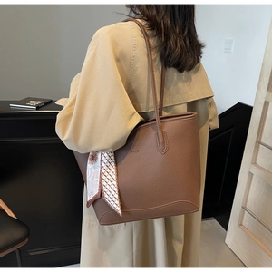 Brown lychee leather tote bag for women with floral scarf detail shown on model