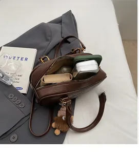 Top view of deep brown leather crossbody bag interior showing spacious storage space