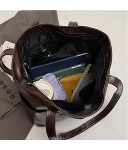 Interior view showing large capacity and compartments of the dark brown tote bag