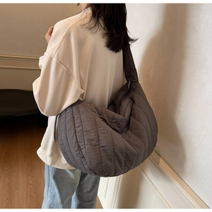Detailed view of the dark grey quilted puffer tote bag with parallel stitching detail