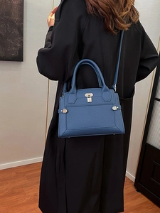 Dark blue litchi pattern leather handbag with metal padlock and shoulder strap