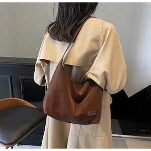 Rear view of brown suede hobo bag with vintage texture and soft drape detail