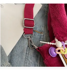 Detailed close-up of premium silver-tone hardware and soft rose red plush faux fur texture