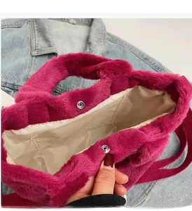 Detail of rose red faux fur bucket bag featuring magnetic silver metal snap closures