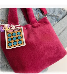 Detail of rose pink plush tote bag with fluffy texture and colorful calculator charm