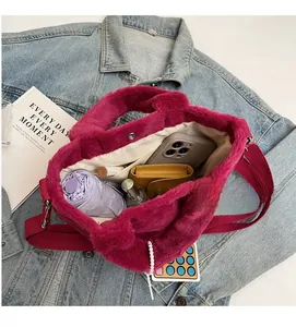 Interior view of fuchsia plush tote bag showing capacity for phone, umbrella, and makeup