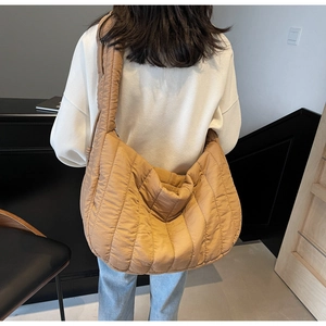 Macro detail of caramel pleated tote bag showing soft quilted texture and spacious design