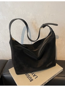 Minimalist black suede hobo bag for women with golden hardware and crescent shape design