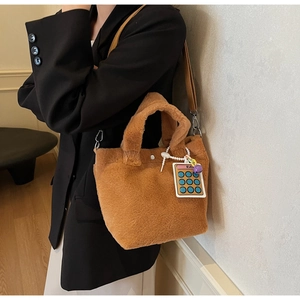 Brown faux fur tote bag with calculator charm and adjustable brown leather strap