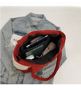 Top view showing the spacious interior of a quilted color-block tote bag with daily items