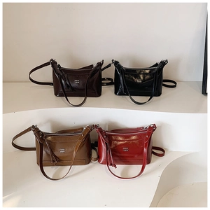 Detailed view of the four color options of this elegant glossy leather crossbody handbag