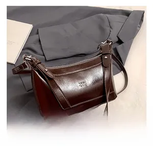 Detail showing deep brown glossy PU leather bag with metal zipper and GOTH ZDIN logo